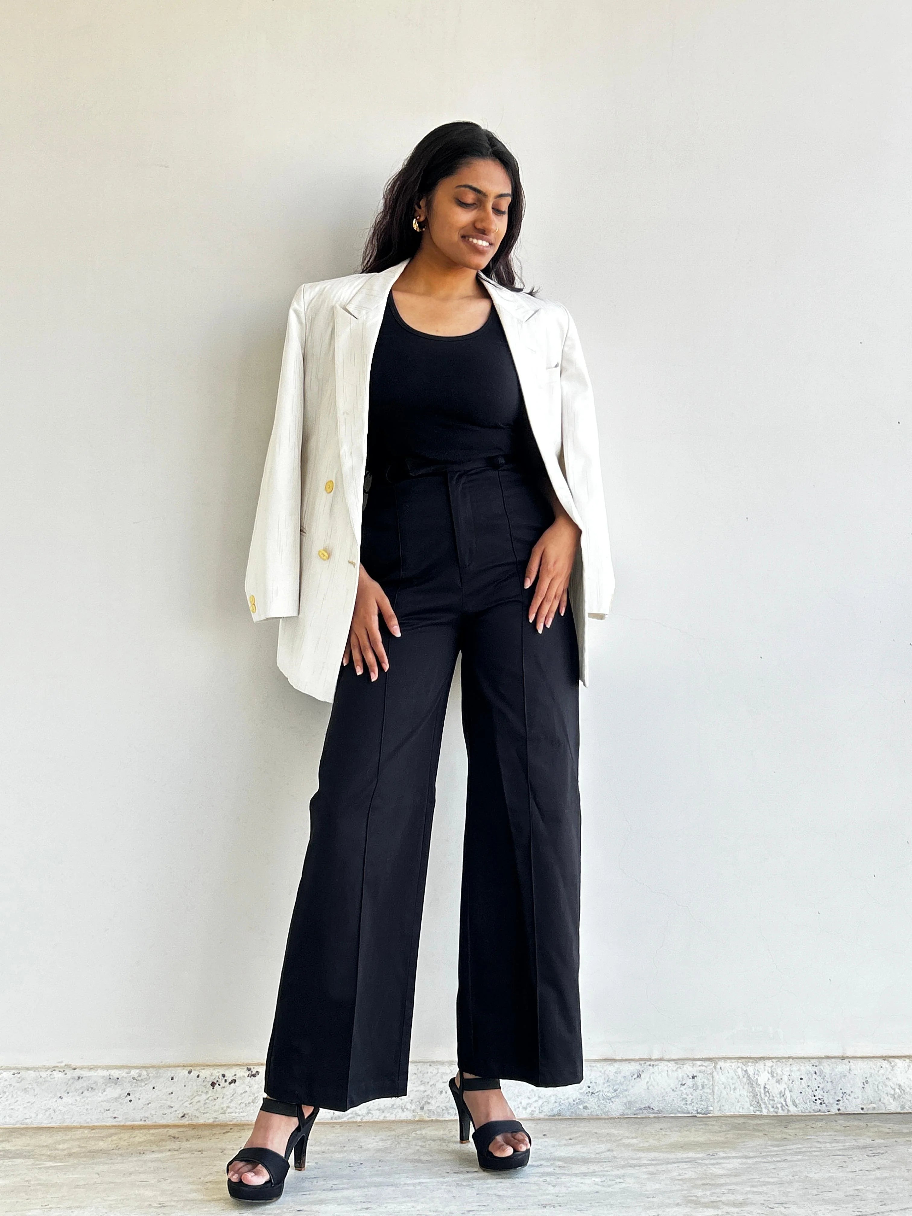 A woman wearing asqeu's black wide leg high rise formal trouser | office pant